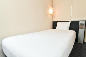Postel nebo postele na pokoji v ubytování Sanco Inn Nagoya Fushimi