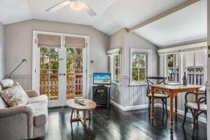 a living room with a couch and a table at Cottage 2 Hyams Beach Seaside Cottages in Hyams Beach