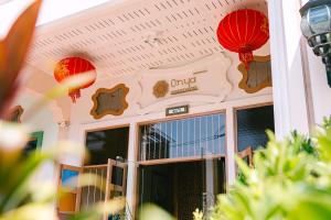 a restaurant with red lanterns in front of a door at O'nya Phuket Hotel in Phuket