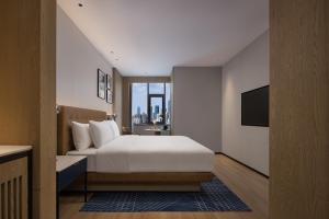 Letto o letti in una camera di Four Points by Sheraton Kunming Dongfeng Square