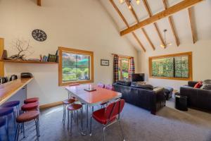 a living room with a table and chairs at Minaret Cabin - 3 bedroom home in Wanaka