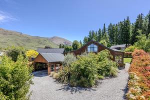 an exterior view of a house with a garden at Minaret Cabin - 3 bedroom home in Wanaka