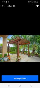a picture of a large wooden pergola at Aloha in Homestead