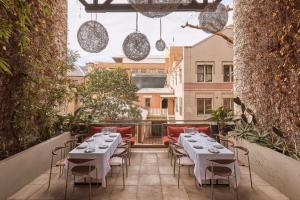 a restaurant with tables and chairs on a balcony at Harbour Rocks by Ode Hotels in Sydney