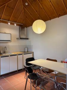 a kitchen with a table and chairs in a room at Kimnung House Anmok in Jeju
