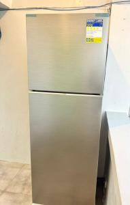 a stainless steel refrigerator in a kitchen at Miami Beach Hotel Boracay in Boracay