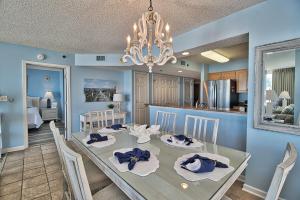 a dining room and kitchen with a dining table and chairs at Oceanfront Crescent Shores Unit 106-Sleep12-4 bedrooms-6 beds-3 bathrooms in North Myrtle Beach
