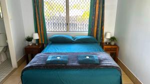 Postel nebo postele na pokoji v ubytování Cooktown Motel