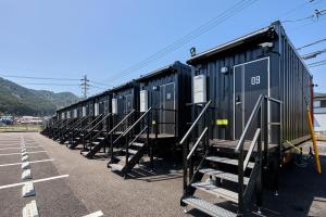 a row of train cars parked in a parking lot at HOTEL R9 The Yard Yamagata in Takatomi +16 photos