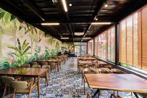 a row of tables and chairs in a restaurant at The Eden Cat Ba in Cat Ba