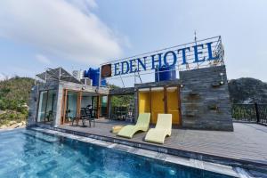 a house with a swimming pool next to a building at The Eden Cat Ba in Cat Ba