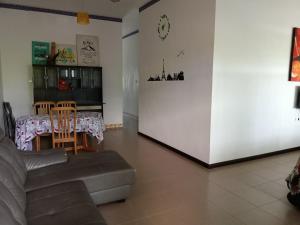a living room with a couch and a table at Marco Polo Rest House in Kuching