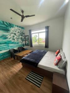 a bedroom with a bed and a ceiling fan at Sky Club Bir Hospitality in Bīr