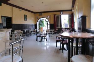 a restaurant with tables and chairs in a room at Hotel Saint Georges Tunis in Tunis