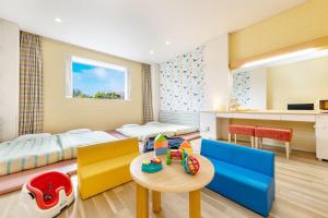 a childrens room with a bed and a table and chairs at Spa Resort Hawaiians VIR Port in Iwaki +70 photos