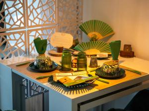 a table with plates and chopsticks on top of it at Appartement de L'Espiguette in Le Grau-du-Roi