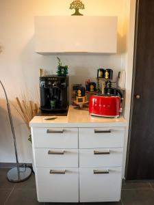 a kitchen counter with a red appliance on it at Appartement de L'Espiguette in Le Grau-du-Roi