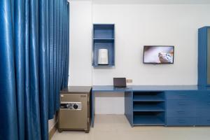 a room with a blue desk and a blue curtain at Skyview Retreat Siem Reap in Siem Reap