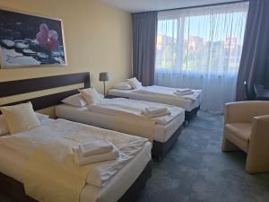Postel nebo postele na pokoji v ubytování Hotel Cascade