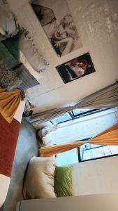 a room with pictures on the ceilings and a window at Maboneng Guest Apartment in Johannesburg