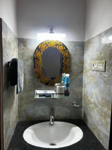 a bathroom with a sink and a mirror at Casa Amore in Benaulim +8 photos