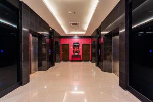 a hallway of a building with red walls and tile floors at MagTree Chinatown in Kuala Lumpur +28 photos