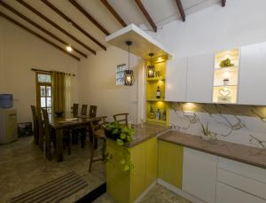 a kitchen and dining room with a dining table at Aloe Serene in Negombo