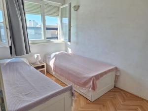 Un dormitorio con dos camas y una ventana. en Apartment Matilda, en Split