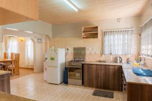 a kitchen with a white refrigerator and a stove at Gatundu Slow Life Farm Stay and Hiking in Tea Farms in Kangunyi +9 photos