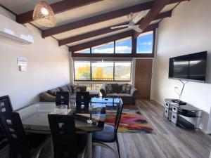 a living room with a table and a tv at Eliza Lee 3 - 3BR Apartment l Air-Con l WiFi l Double Garage in Jindabyne