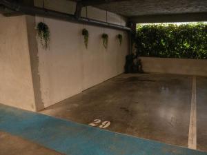 an empty parking garage with plants on the wall at Appartement de L'Espiguette in Le Grau-du-Roi