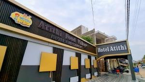 a building with a sign for a book store at Hotel Atithi Food Village in Etāwah