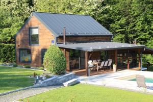 a house with a solar roof on top of it at Villa Green Relax in Gornji Mihaljevec
