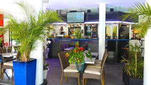 a restaurant with a bar with potted plants at #Cannes Boccacabana Beach, Seafront, in Résid Pierre&Vacances 3 Stars in Cannes