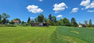 a house on top of a green field at Cube Hills in Rakovica