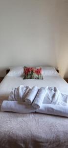 a white bed with two towels on top of it at Casa Vitorino in Leiria +42 photos