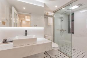 a white bathroom with a sink and a shower at 重庆大野江景民宿 in Chongqing +114 photos