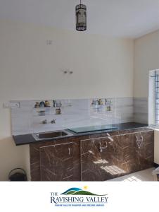 a kitchen with a sink and a counter top at The Ravishing Valley in Ketti +21 photos