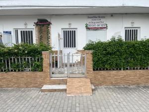 a white building with a gate in front of it at Sweetmar guest Rooms-ground floor in Kos +21 photos