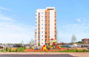 a playground in front of a tall building at Apartament sector 5 Sara in Bucharest