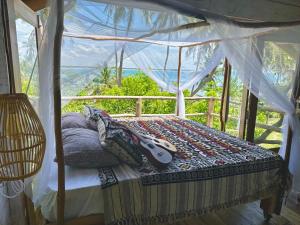 a bedroom with a bed with a guitar on it at The Tree House in Arugam Bay