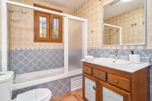 a bathroom with a sink and a tub and a toilet at Villa Javier en Sayalonga in Sayalonga +34 photos