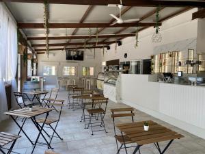a restaurant with tables and chairs in a room at Romea Family Camping in Casal Borsetti