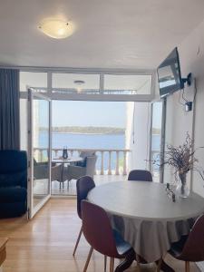 a living room with a table and a view of the ocean at Prizba Tomas in Blato
