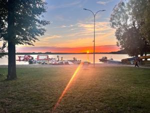 a sunset on the beach with a rainbow in the grass at Siedlisko Kochówka in Pszczew +7 photos