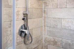 a shower with a shower head in a bathroom at Camere Amè in Peschiera del Garda +51 photos