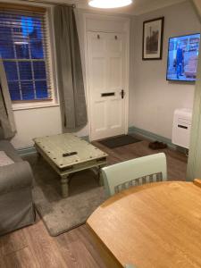 a living room with a table and a couch at The Old Penny Bank in Barrow upon Humber