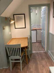 a dining room with a table and a chair at The Old Penny Bank in Barrow upon Humber