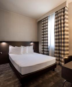 Postel nebo postele na pokoji v ubytování Hotel Ovest