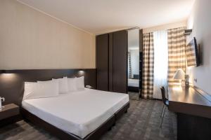 Postel nebo postele na pokoji v ubytování Hotel Ovest